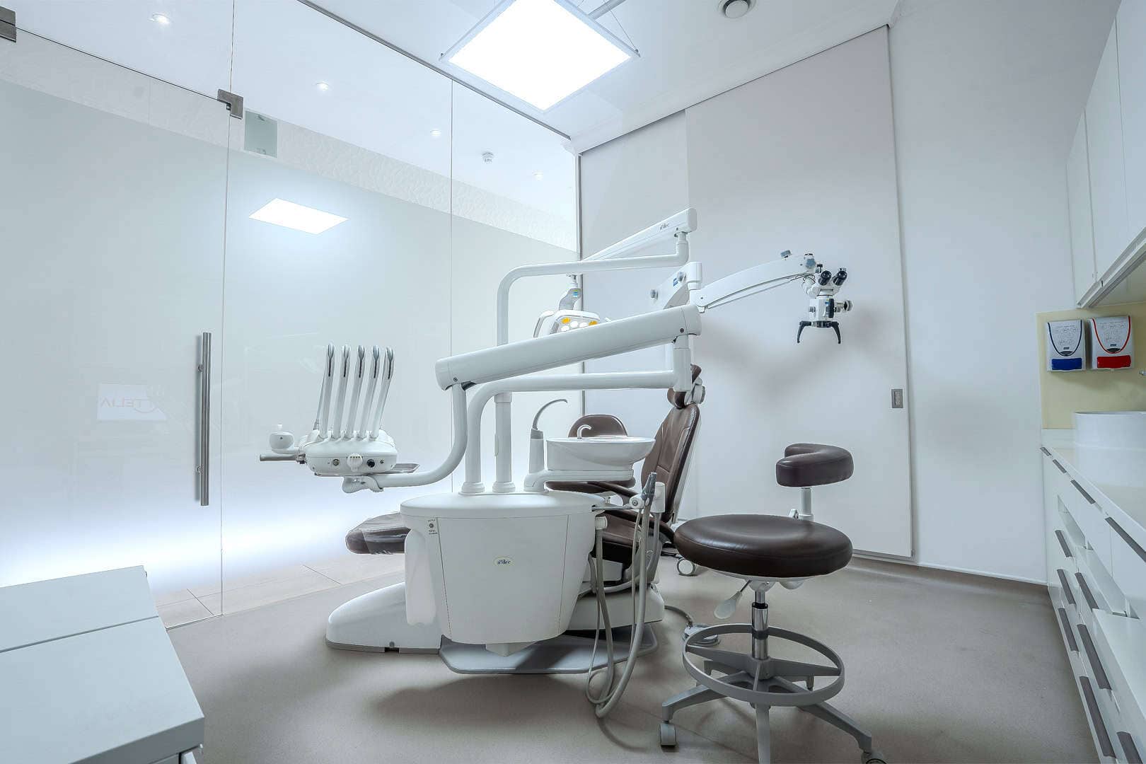 Dental treatment room with modern equipment and dental chair.